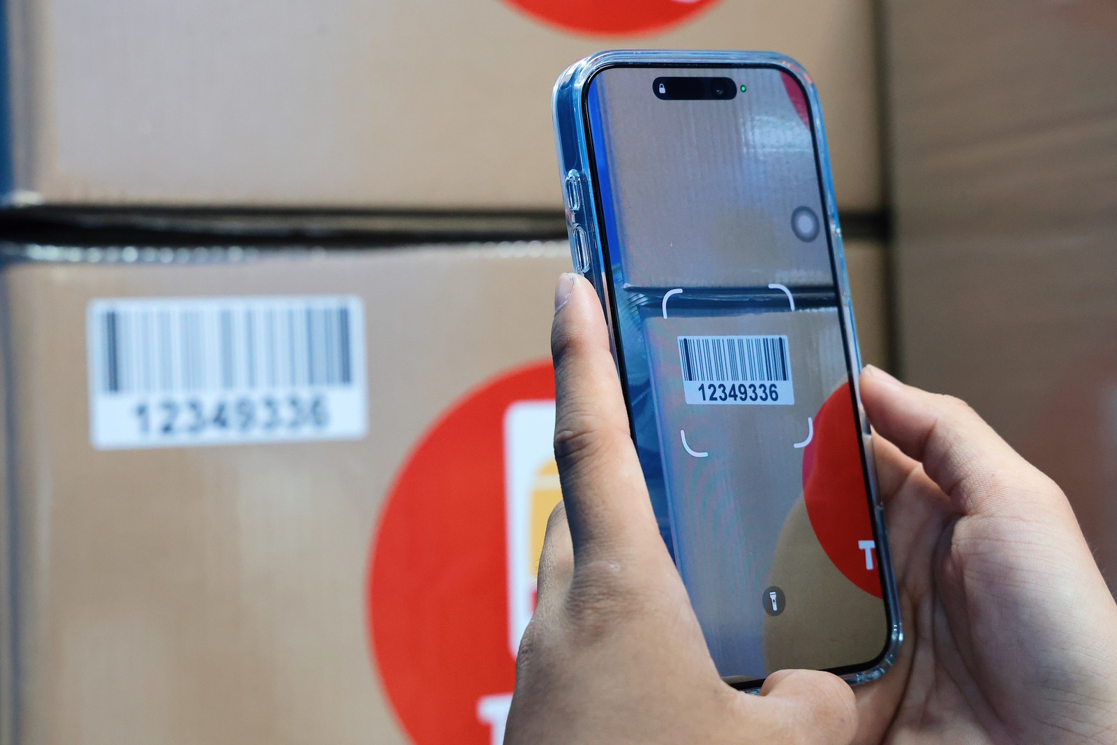 A phone reading the barcode on a box inside the facility