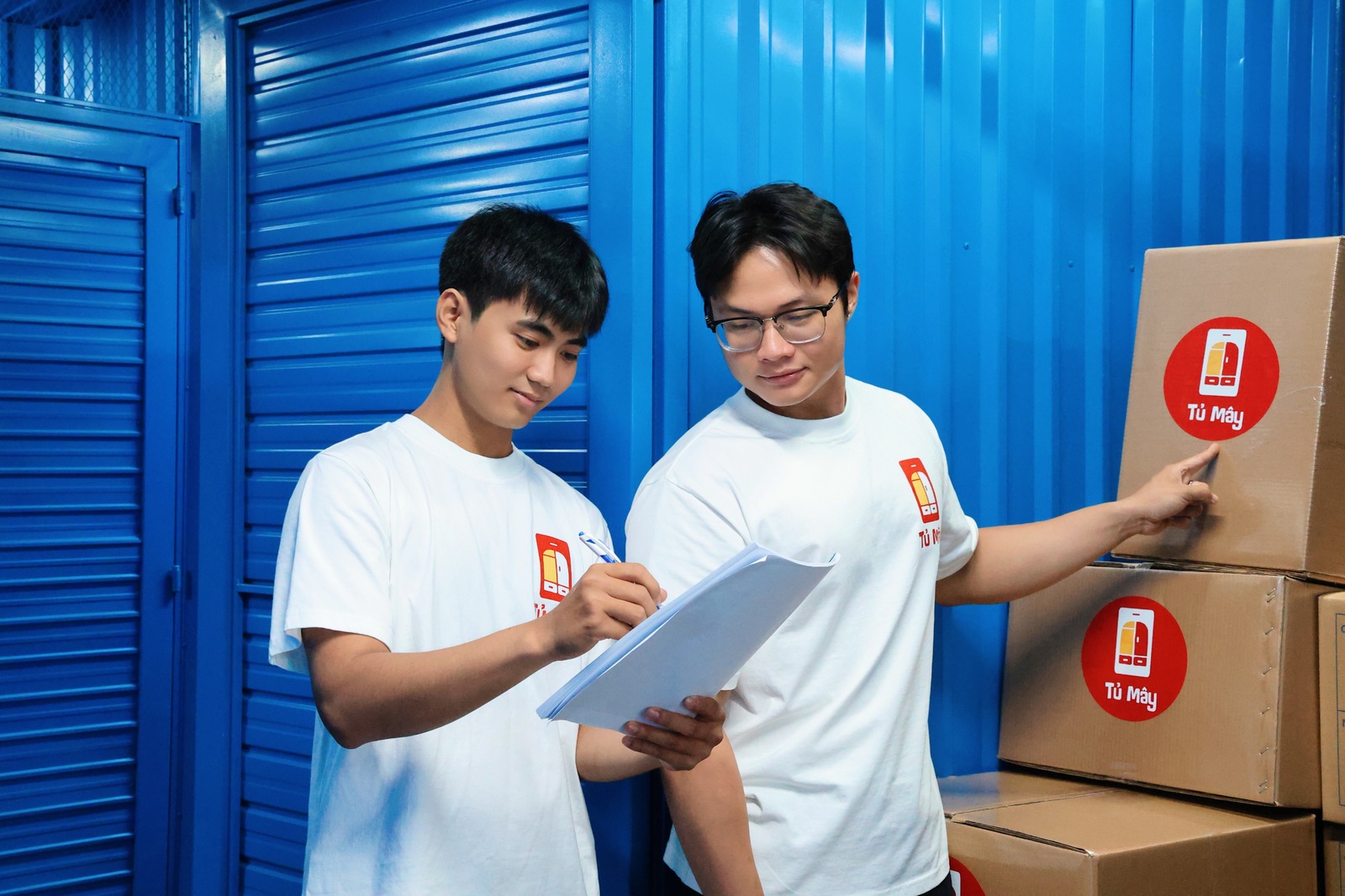 Two crew members checking a labelled box together
