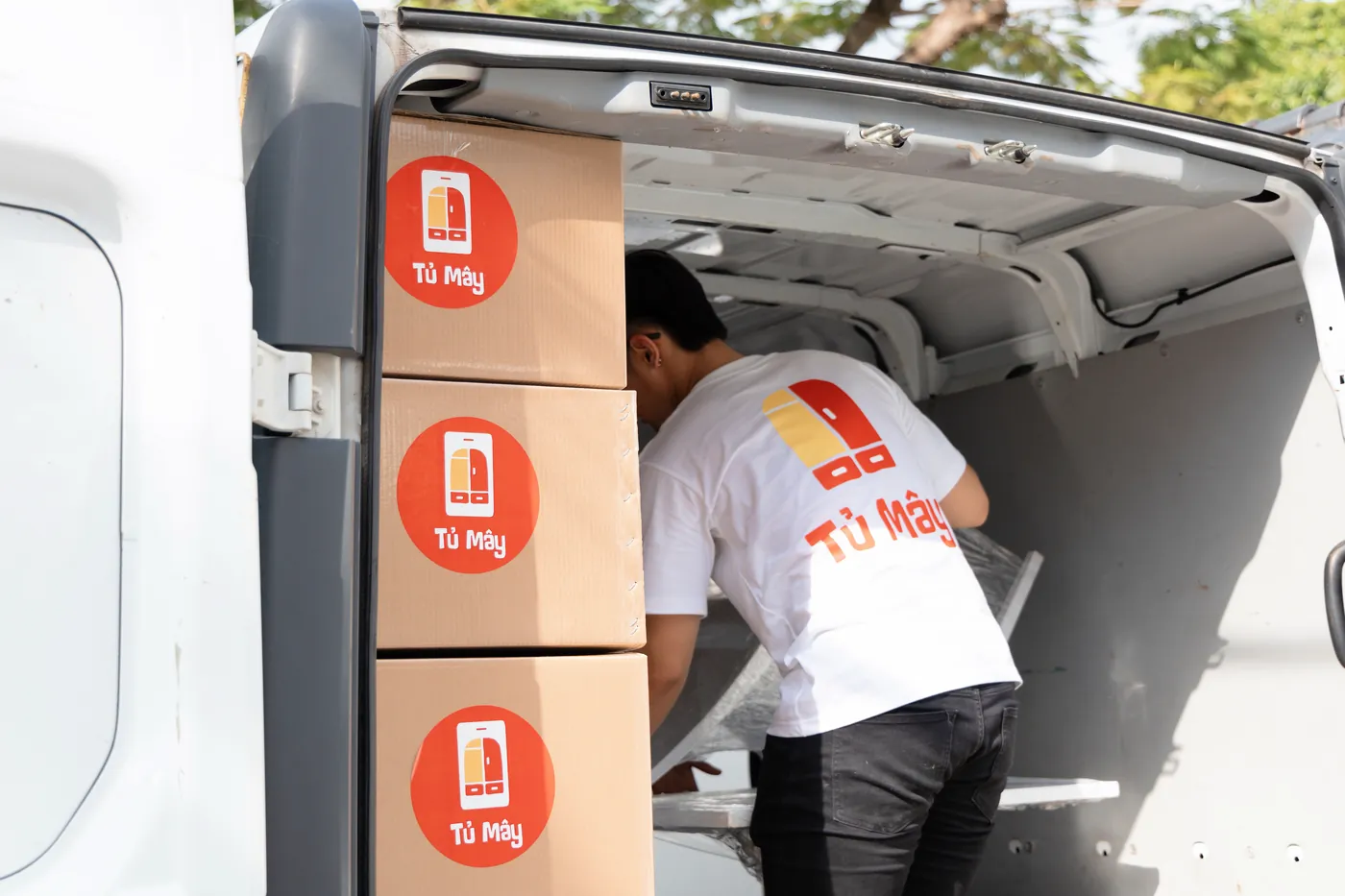 Tủ Mây boxes stacked inside the van, ready to leave for the facility